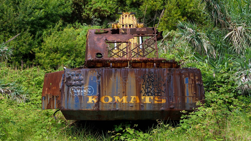 a rusted out train car sitting in a field