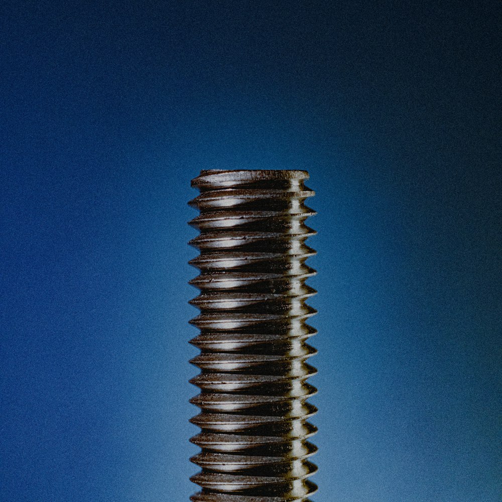 a close up of a screw on a blue background