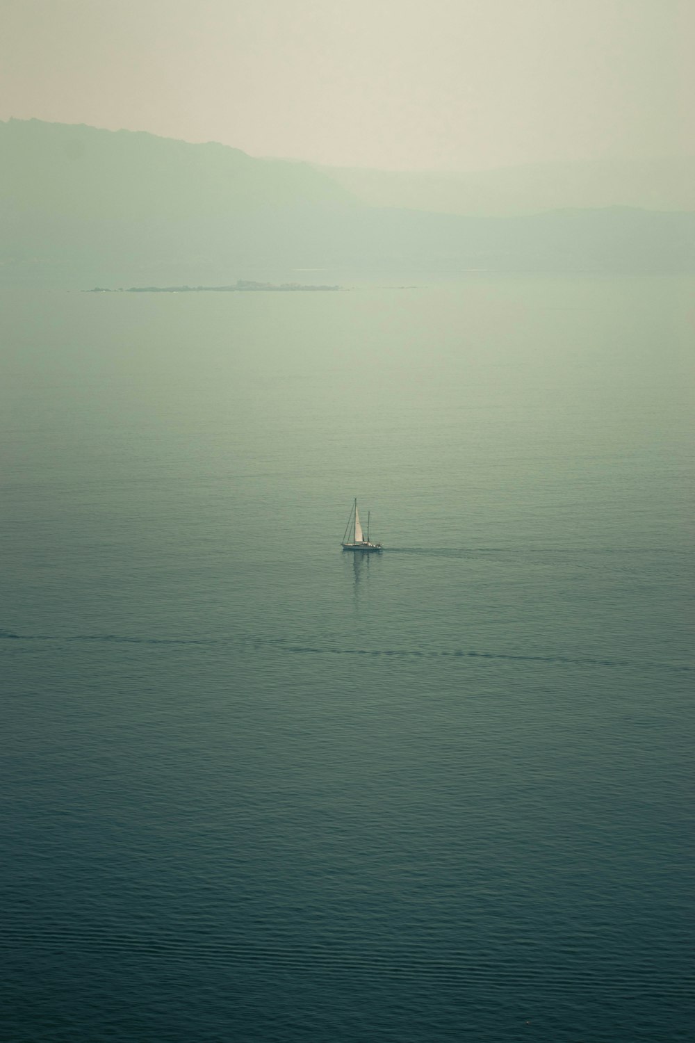 a boat is out in the middle of the ocean