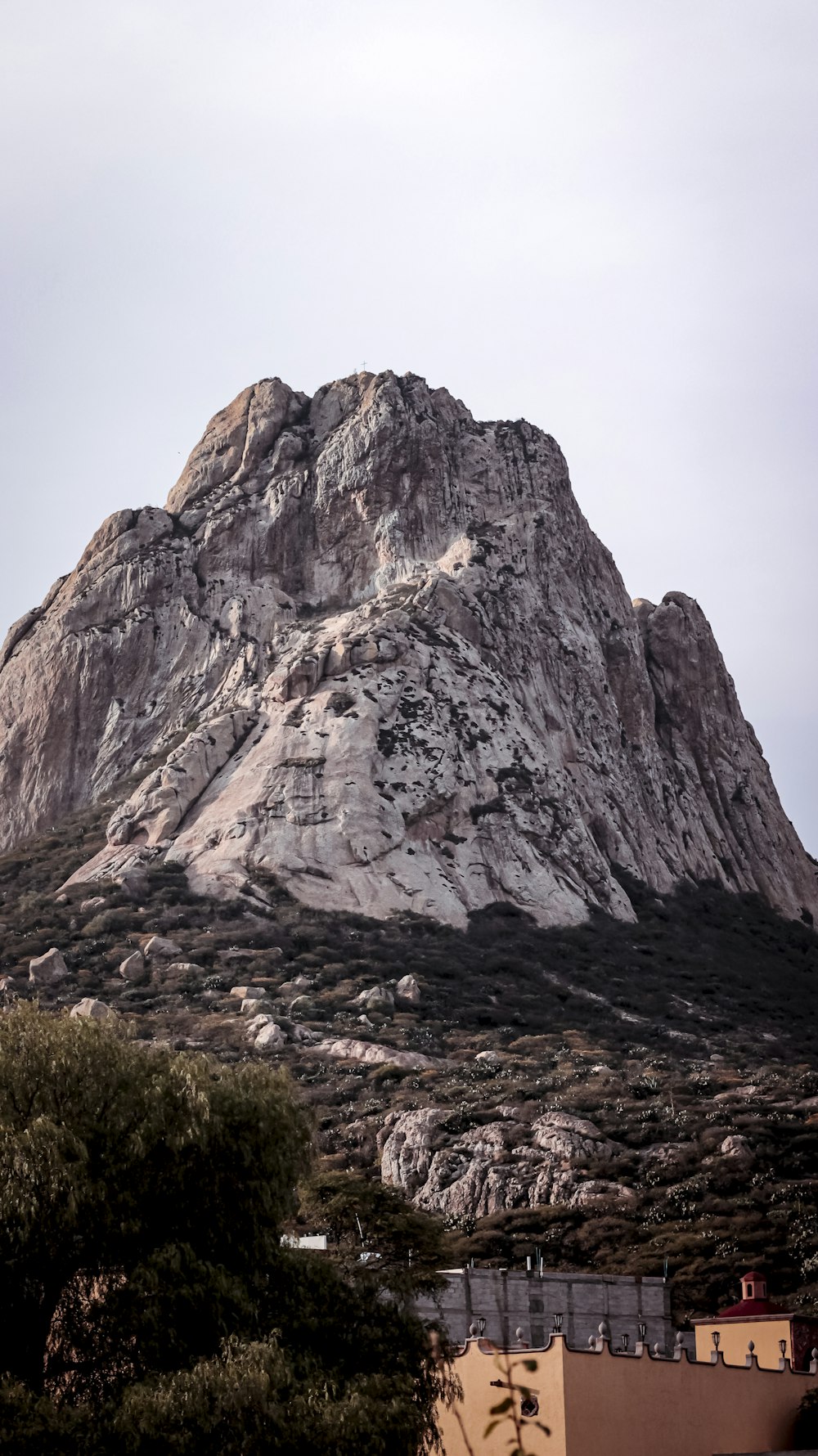 a very tall mountain towering over a city