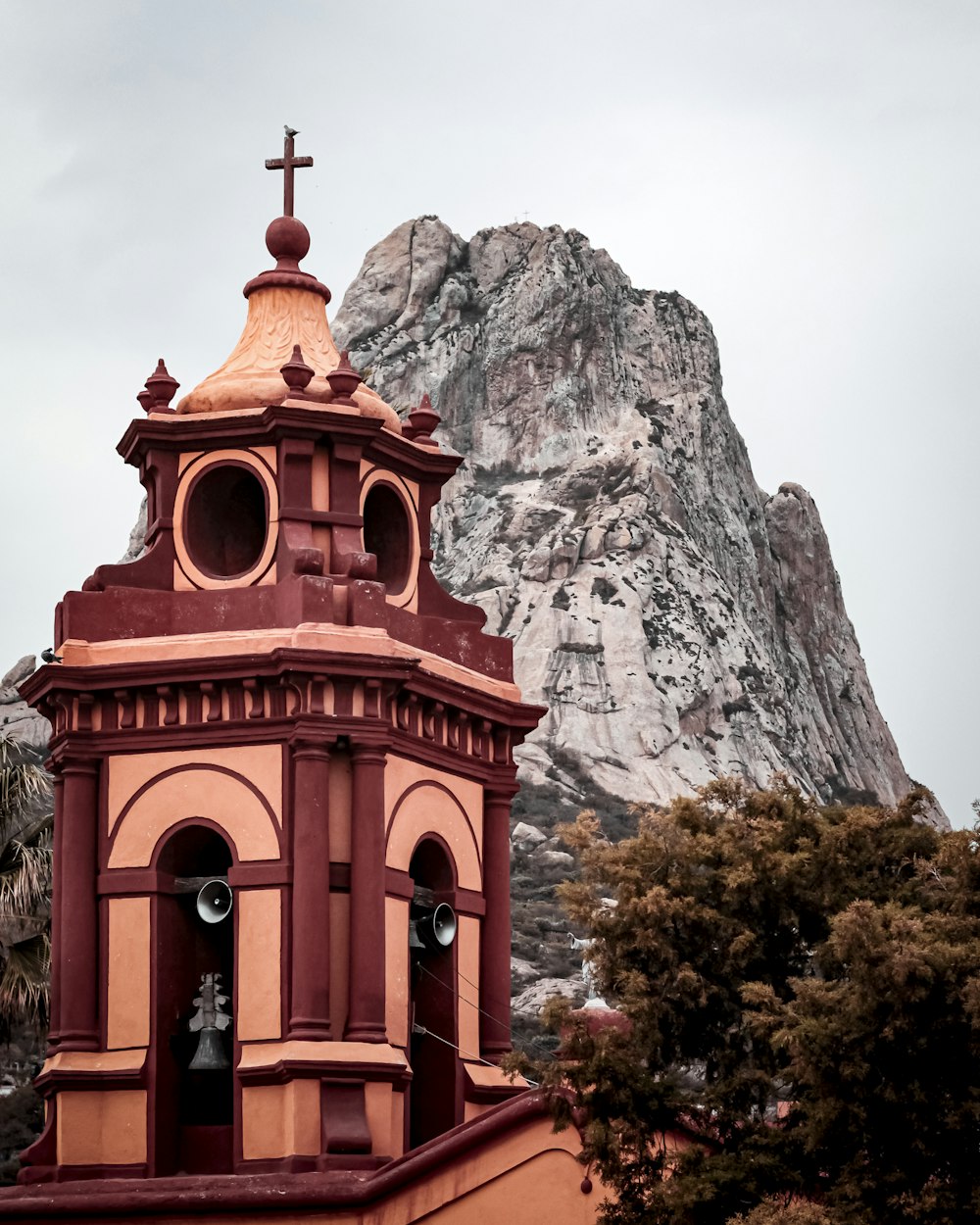 a church steeple with a cross on top of it