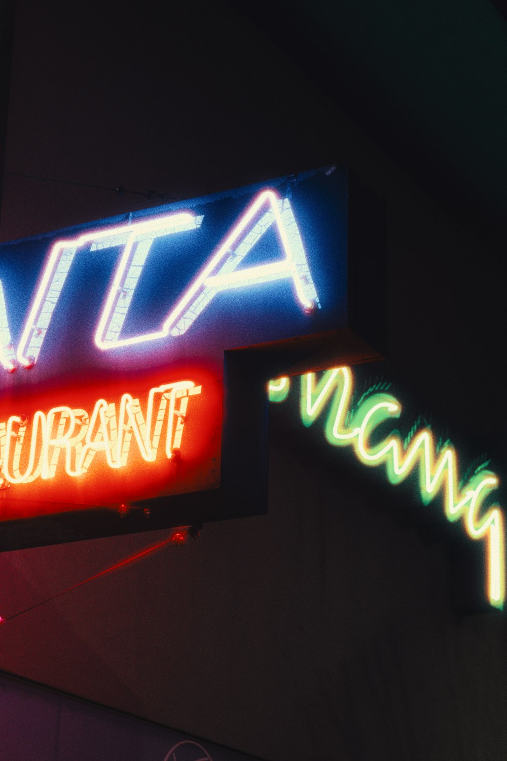 a neon sign for a restaurant that is lit up