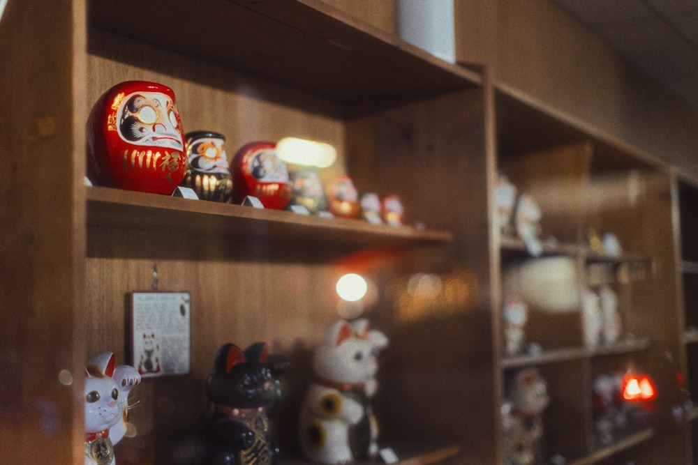 a shelf filled with lots of different types of figurines