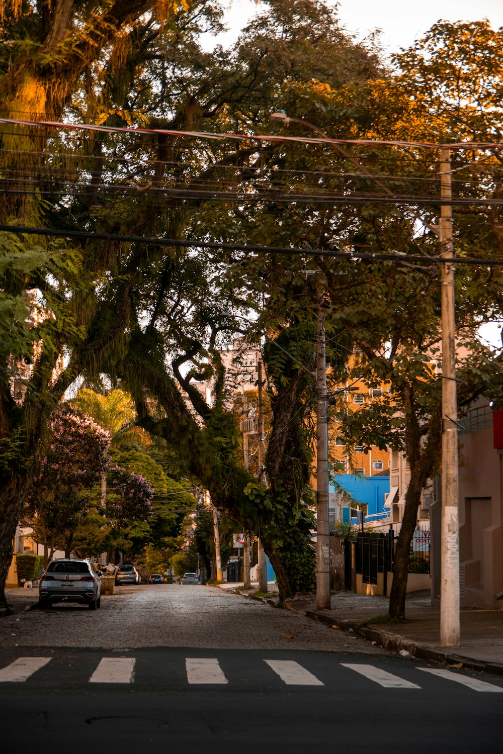 a city street with a car parked on the side of the road