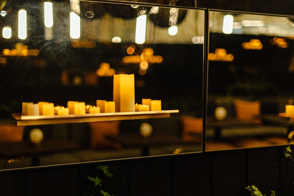 a display of candles in a glass case