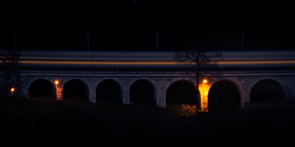 a lit up bridge at night with lights on