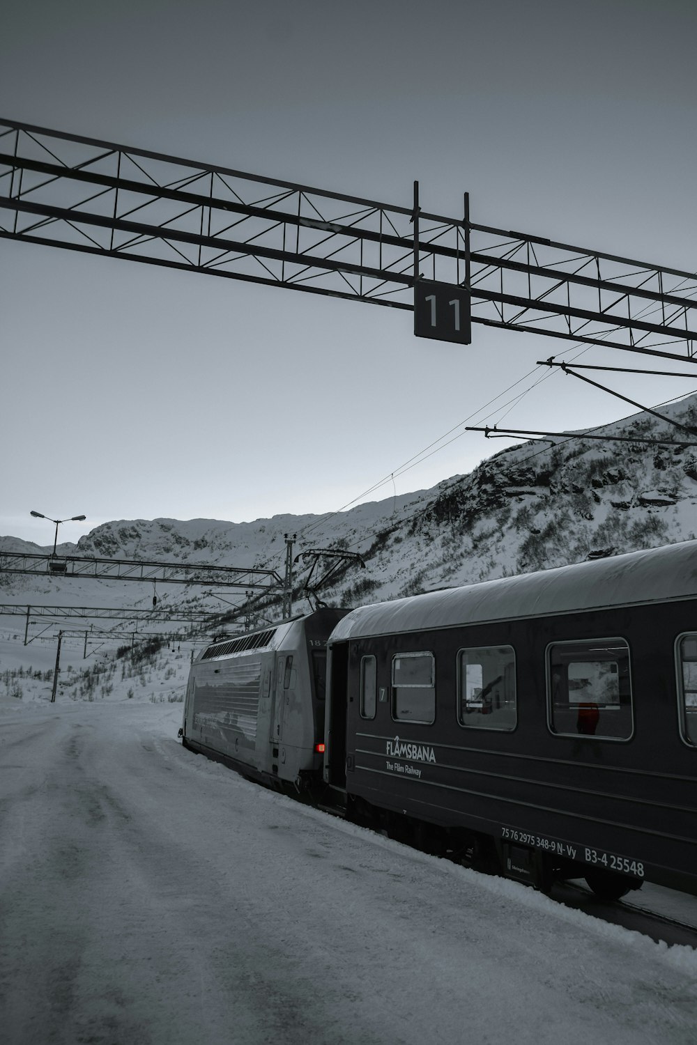 a black and white photo of a train on the tracks