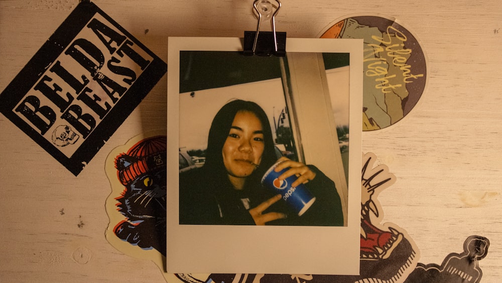 a picture of a woman holding a can of soda