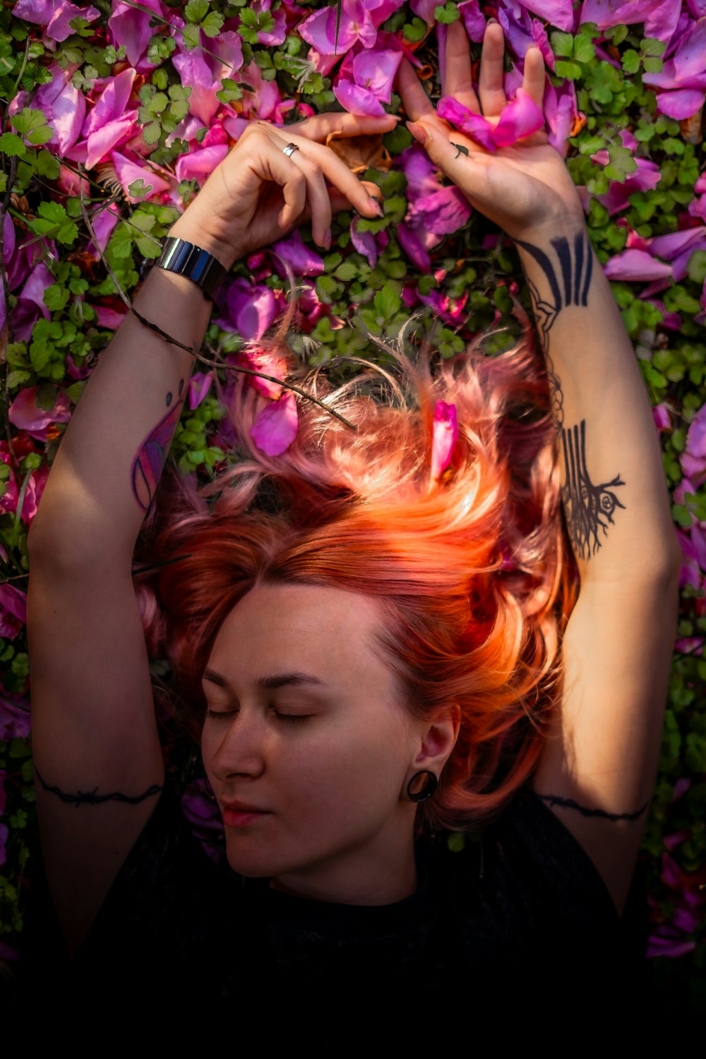 a woman with red hair laying on the ground