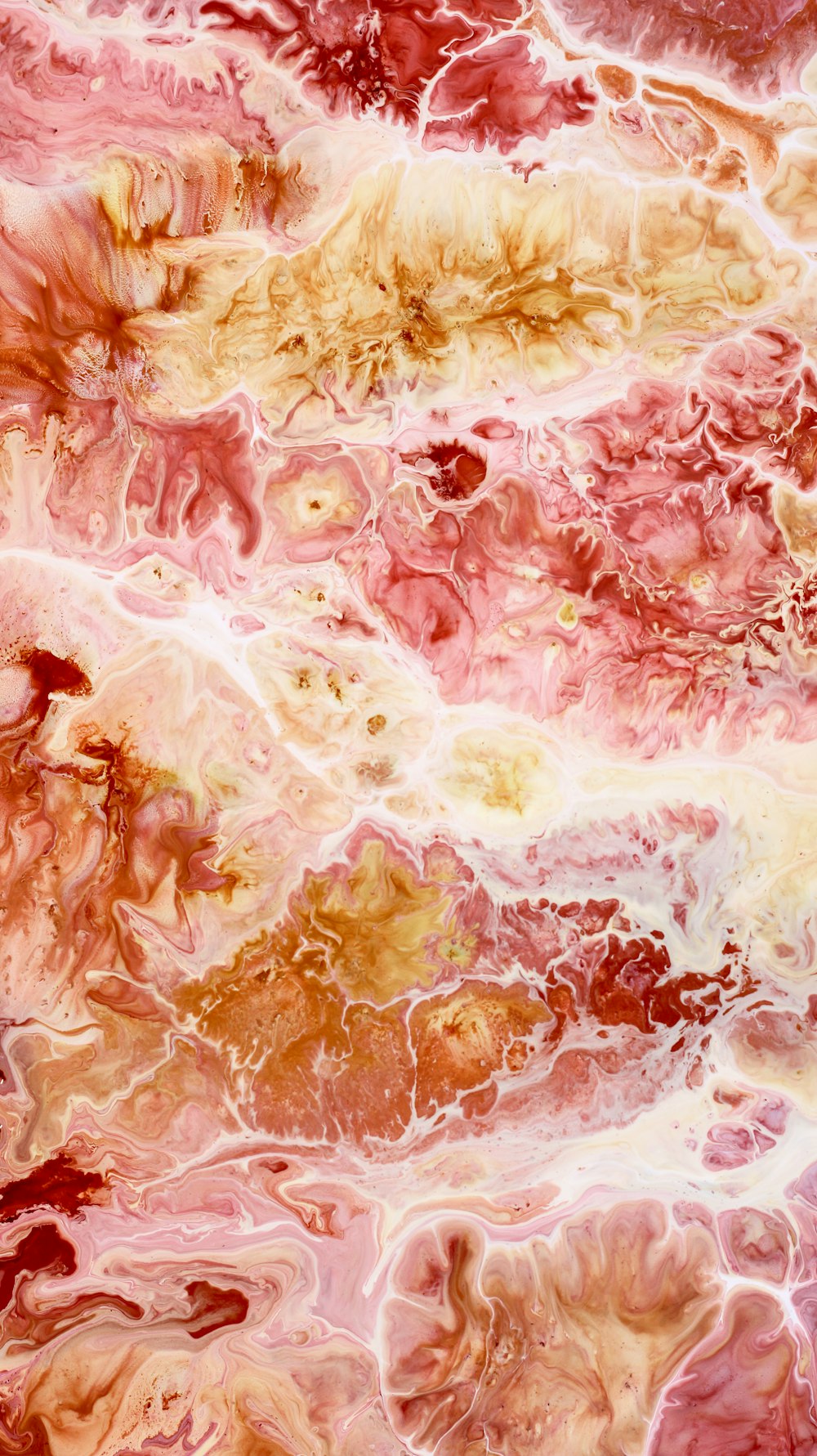 a close up of a pink and yellow marble