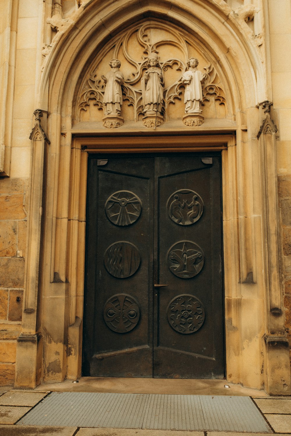 a large black door in front of a stone building