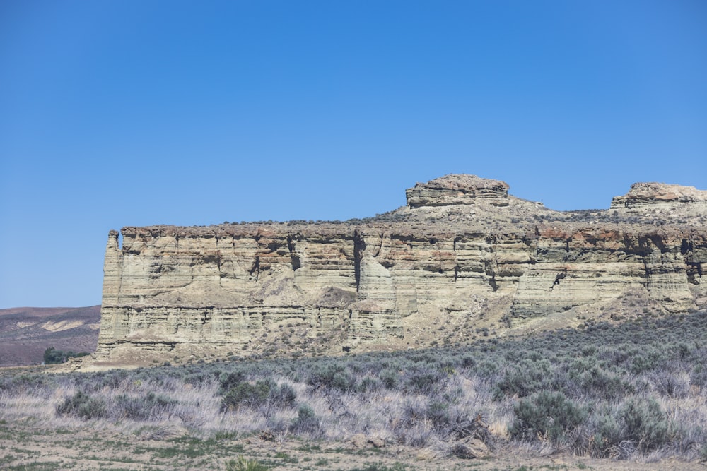 a large rock formation in the middle of a desert