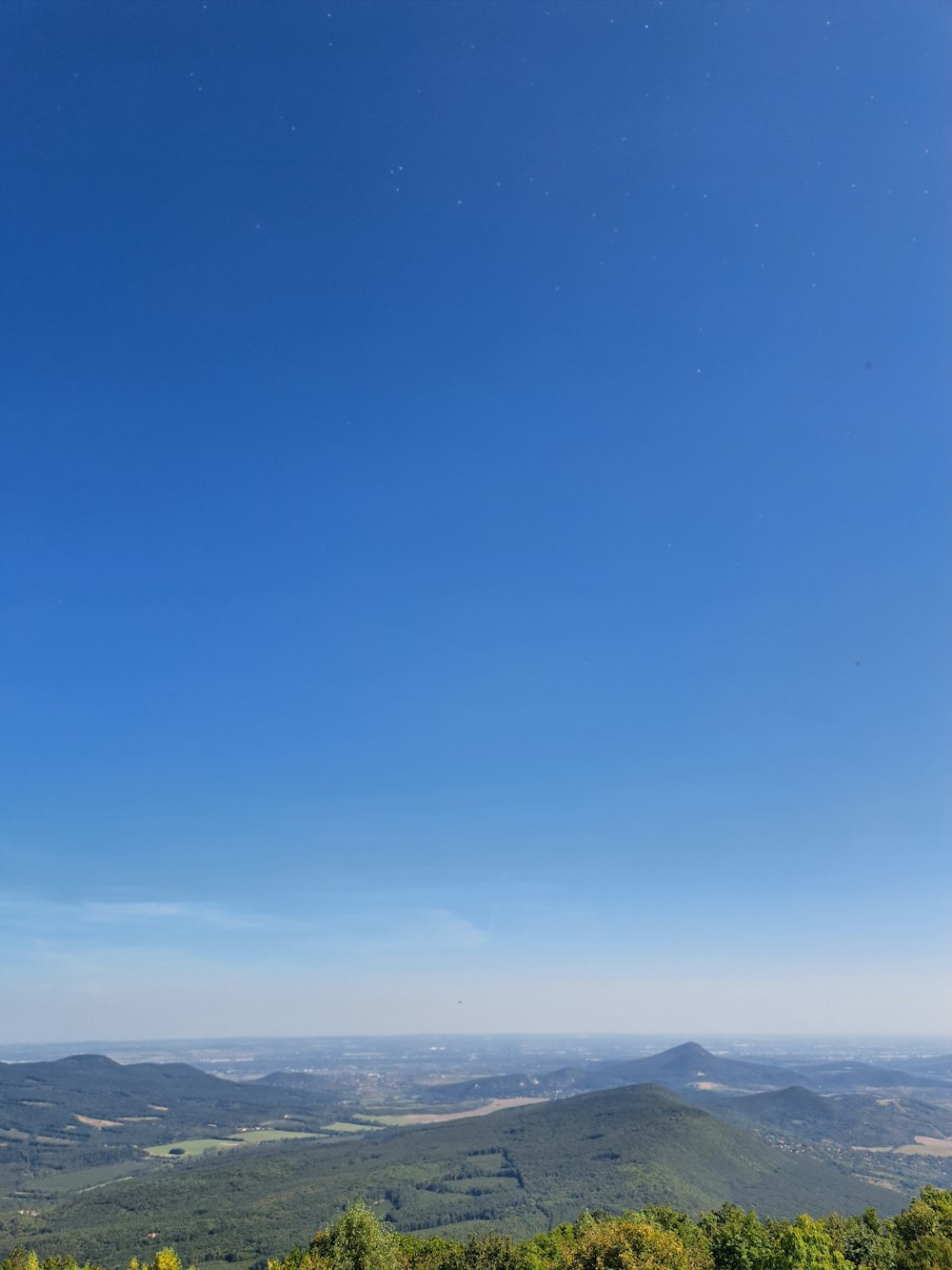 a bench on a hill overlooking a valley