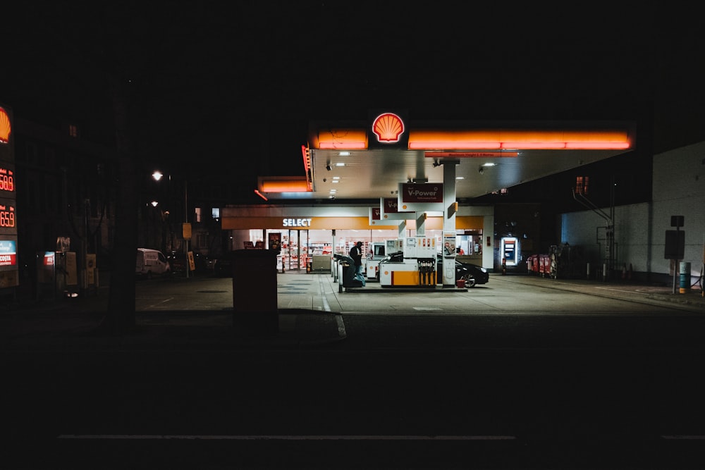 a gas station at night with neon lights