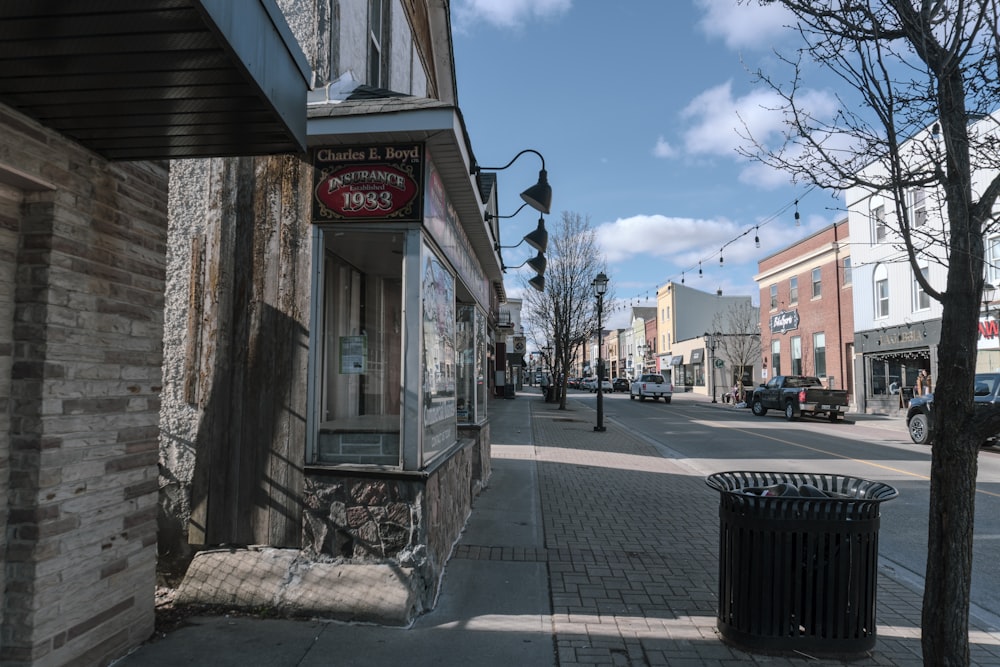 a city street with a trash can on the side of it