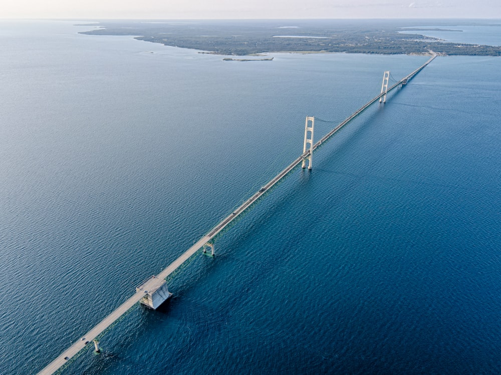 an aerial view of a bridge in the middle of the ocean