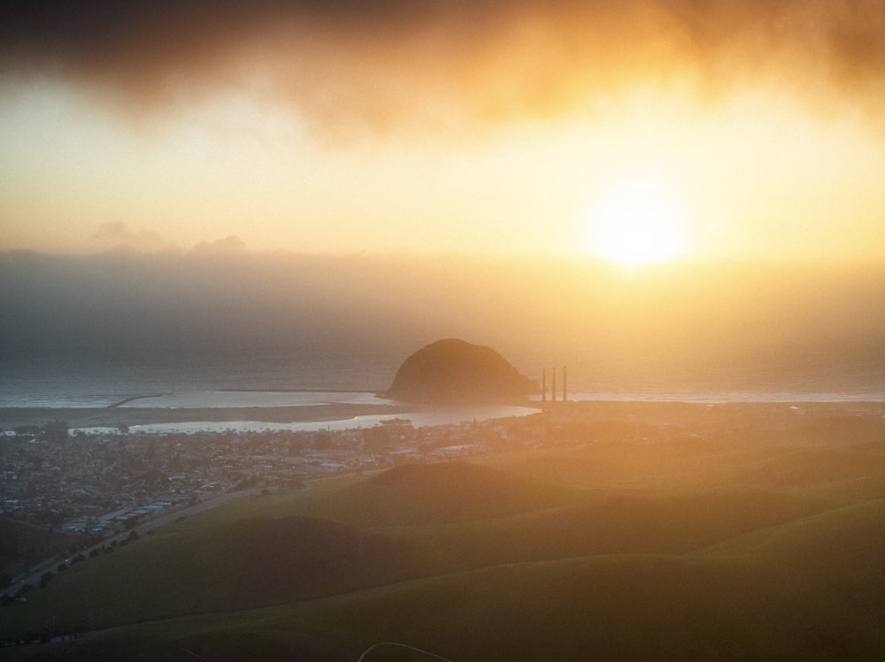 a view of the sun setting over a city