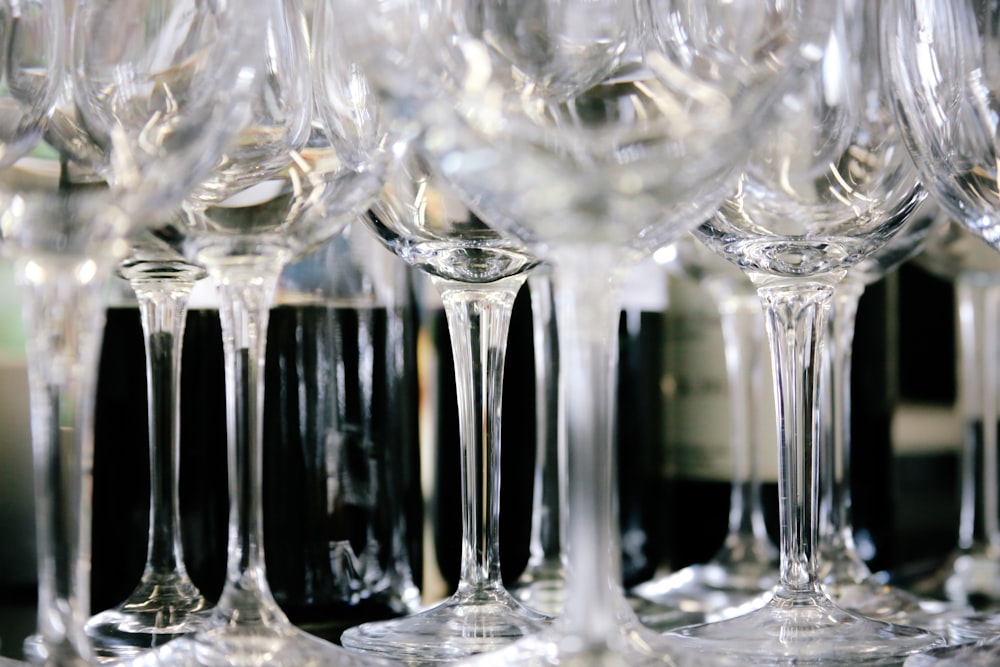 a row of wine glasses sitting on top of a table