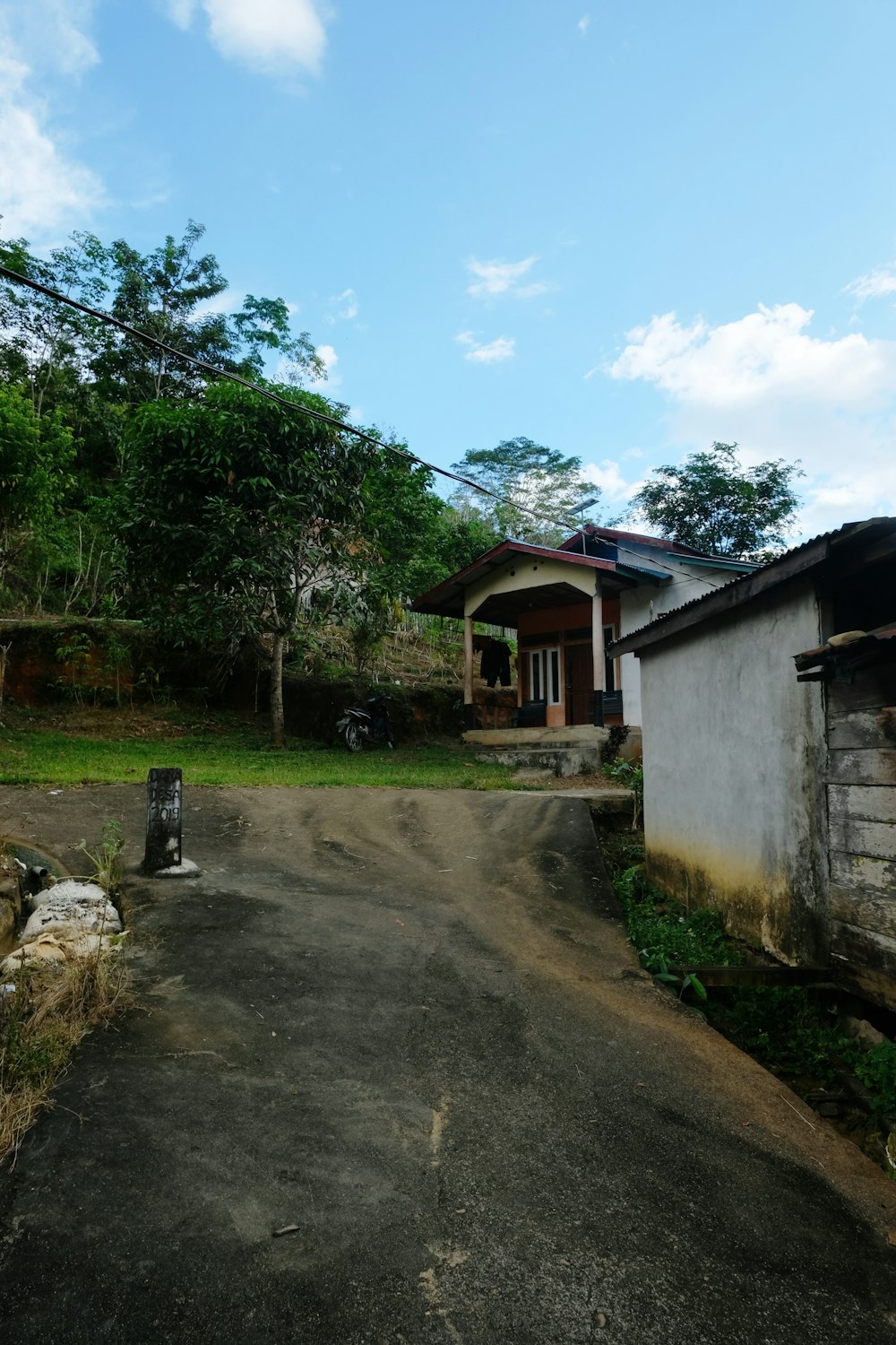 a dirt road in front of a house