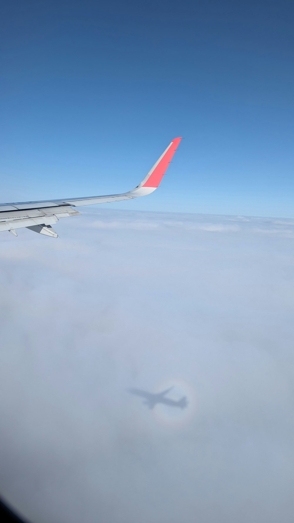 a view of the wing of an airplane in the sky