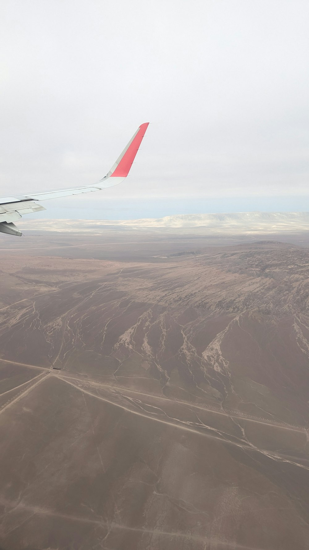 a view of the wing of an airplane in the sky