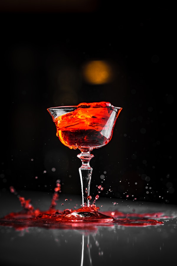 A red liquid splashing out of a wine glass