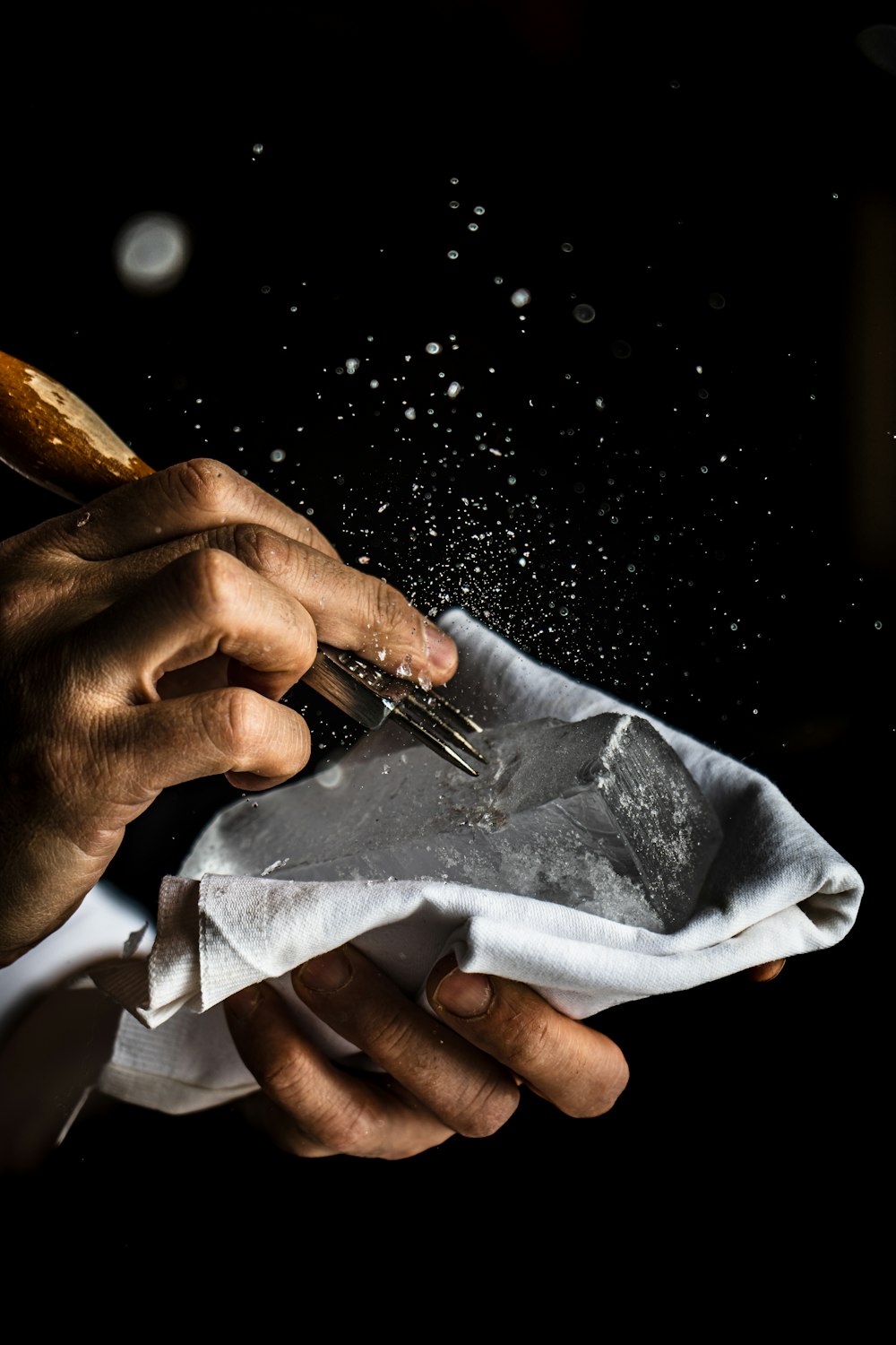 a person cutting a piece of paper with a pair of scissors