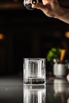 a person pouring a glass of wine into a glass