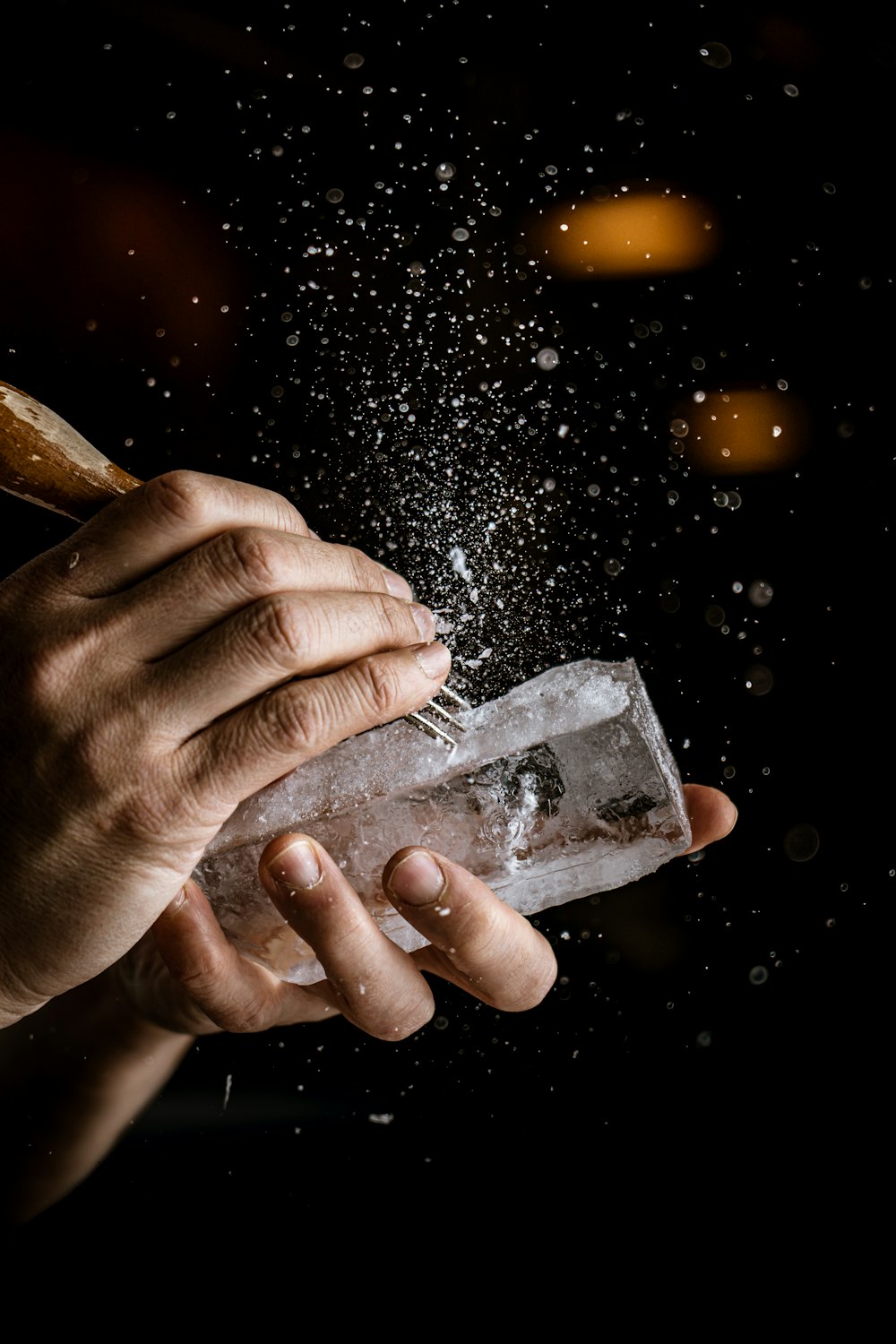 a person holding an ice block in their hand