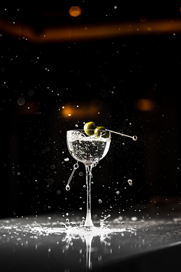 A martini glass with an olive in it