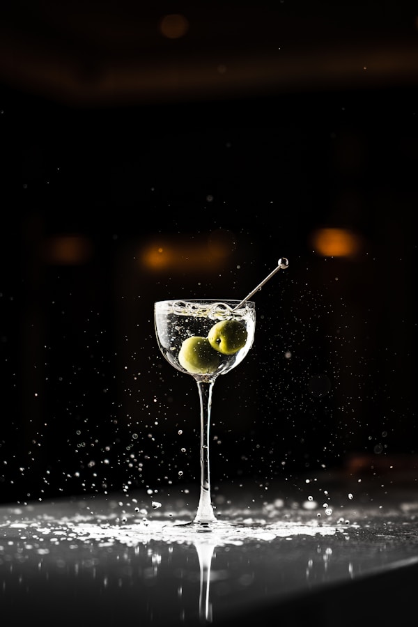 A martini glass with an olive in it