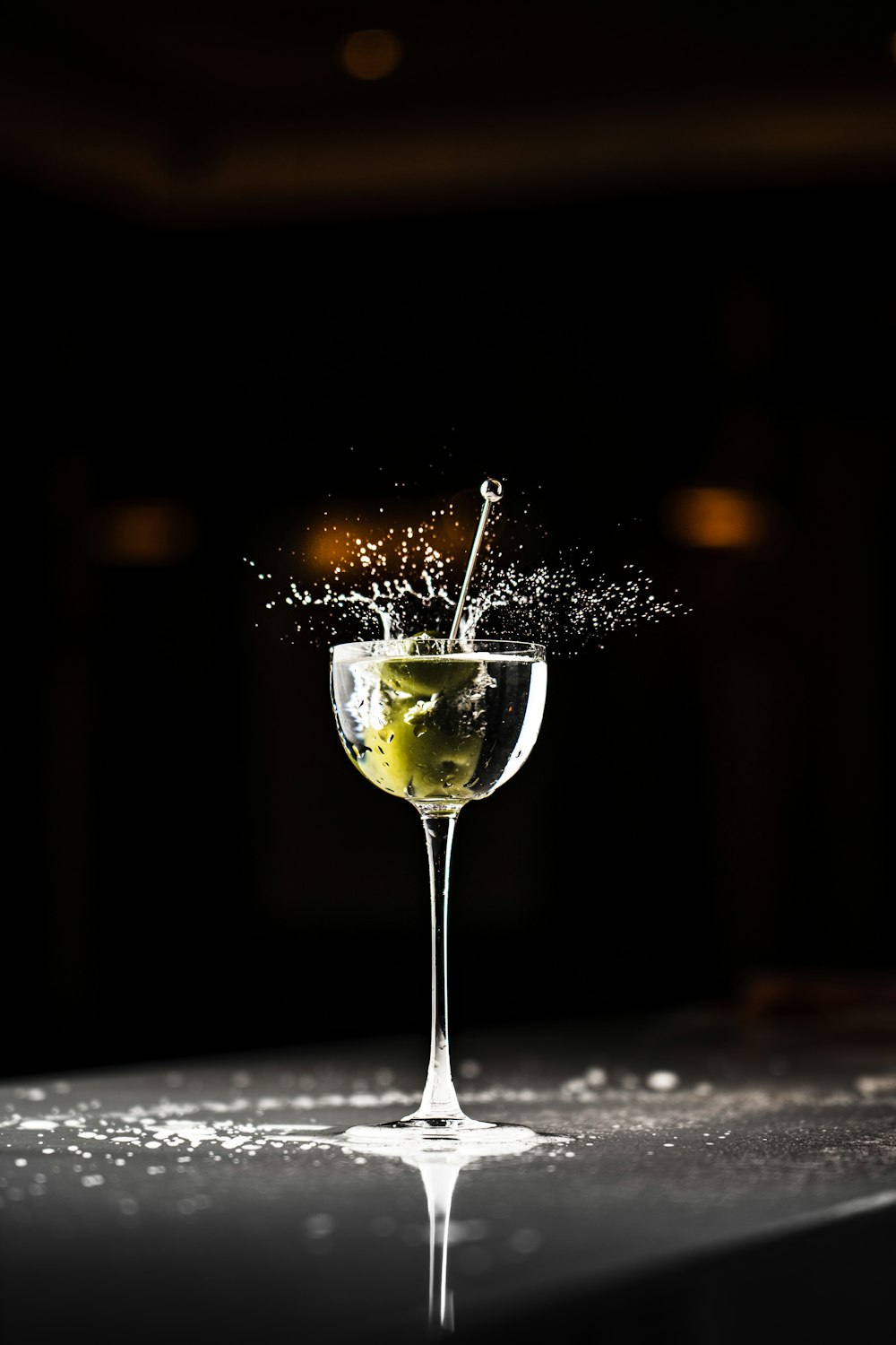 a glass filled with liquid on top of a table