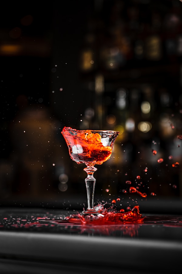 A red liquid splashing out of a wine glass