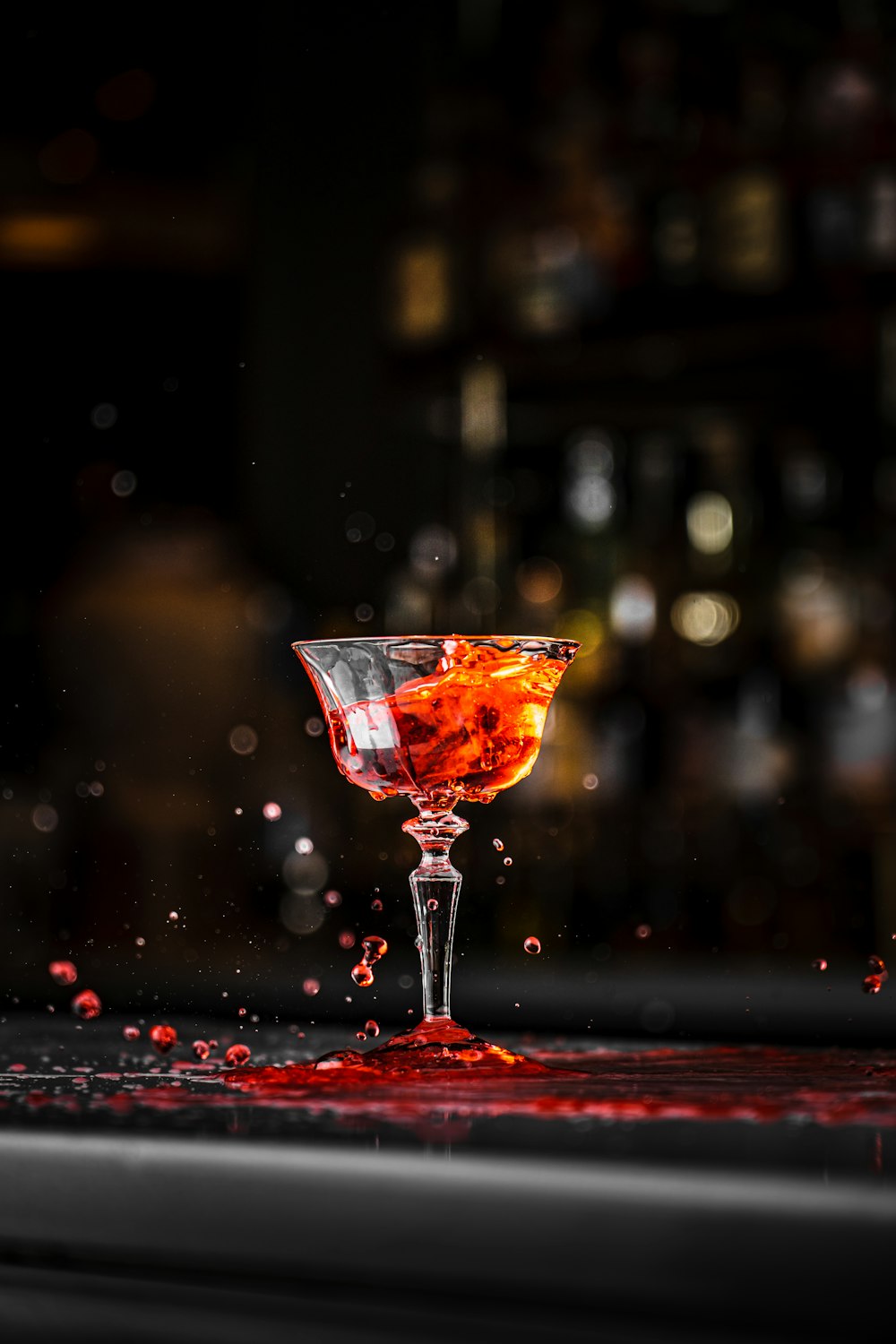 a glass filled with liquid sitting on top of a table