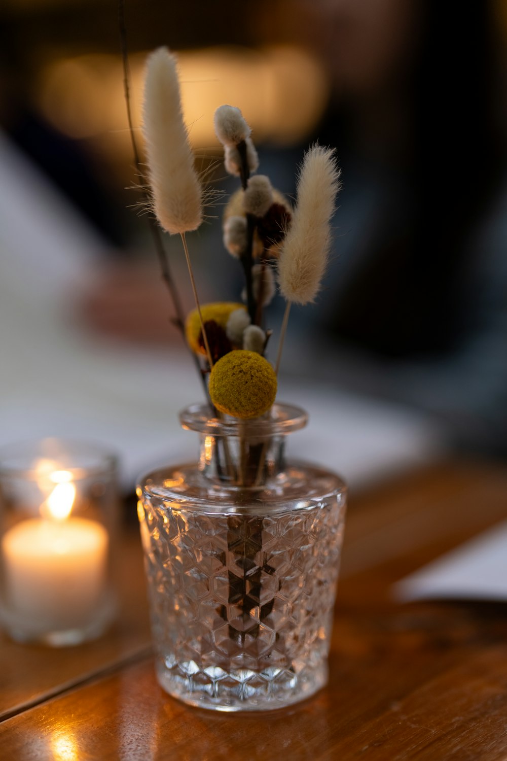 a glass vase with some flowers in it