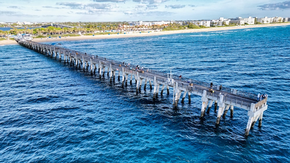 a long pier stretches out into the ocean