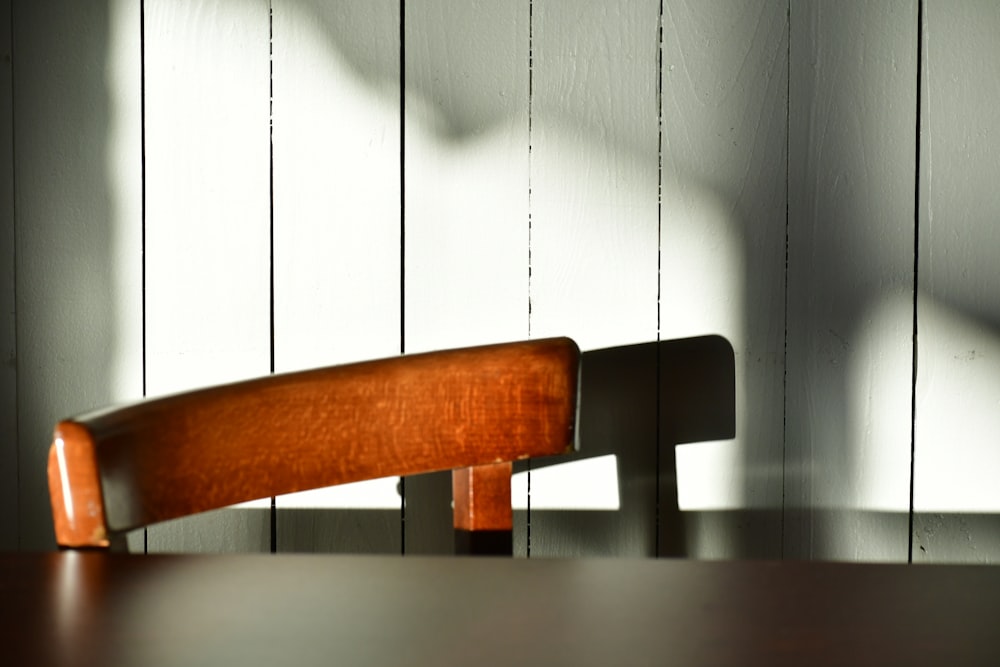 a wooden chair sitting on top of a wooden table