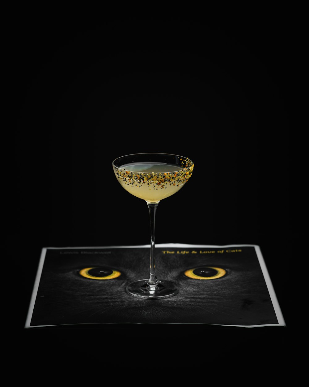 a cat's eye is shown in a martini glass