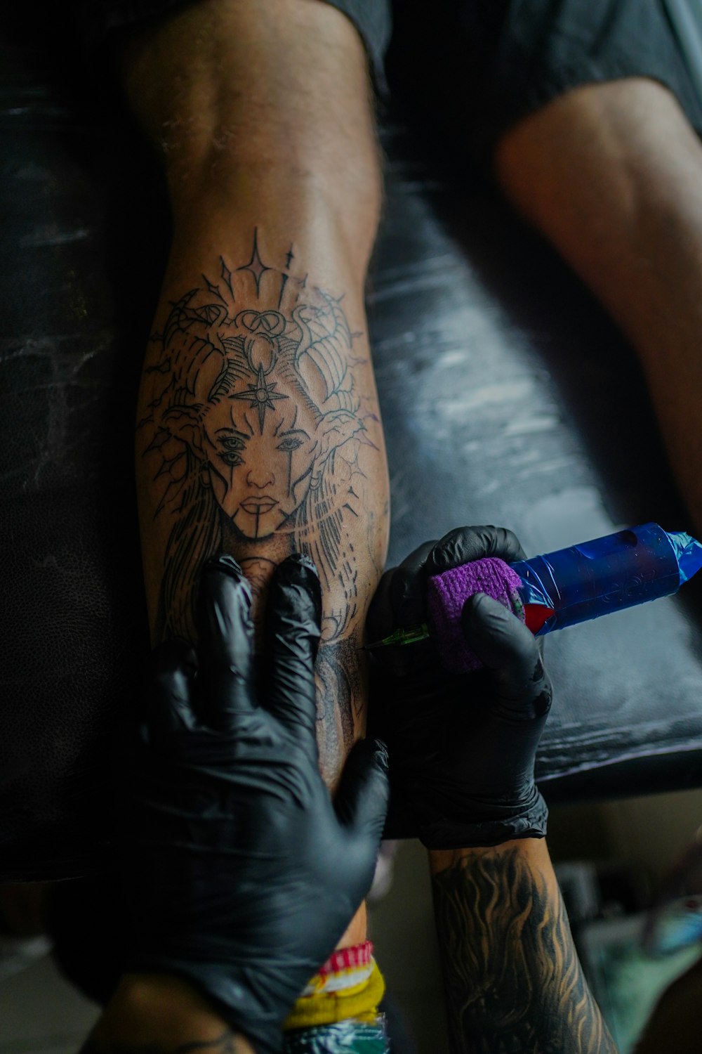 a man with a tattoo on his arm holding a lighter