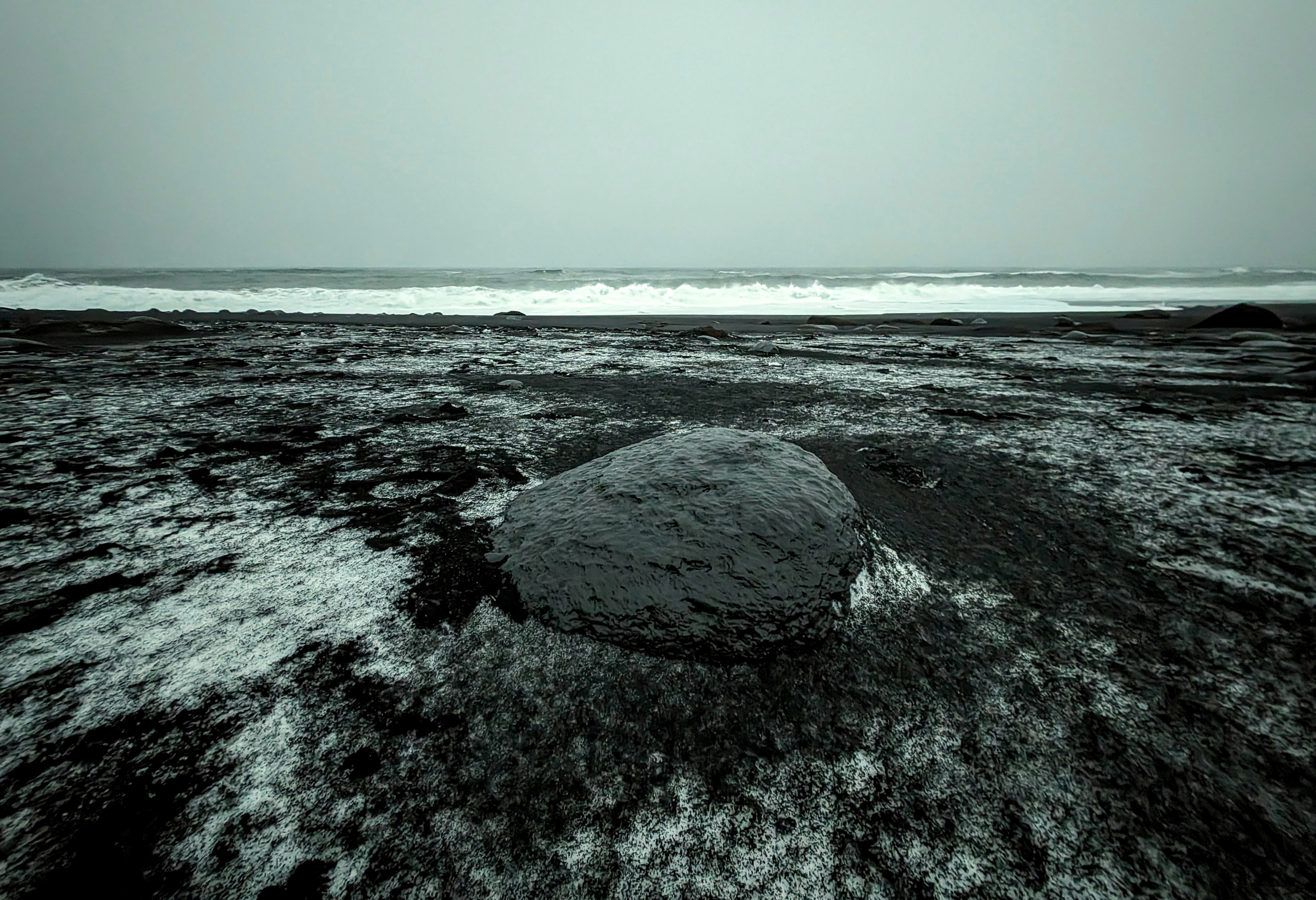 a rock in the middle of a body of water