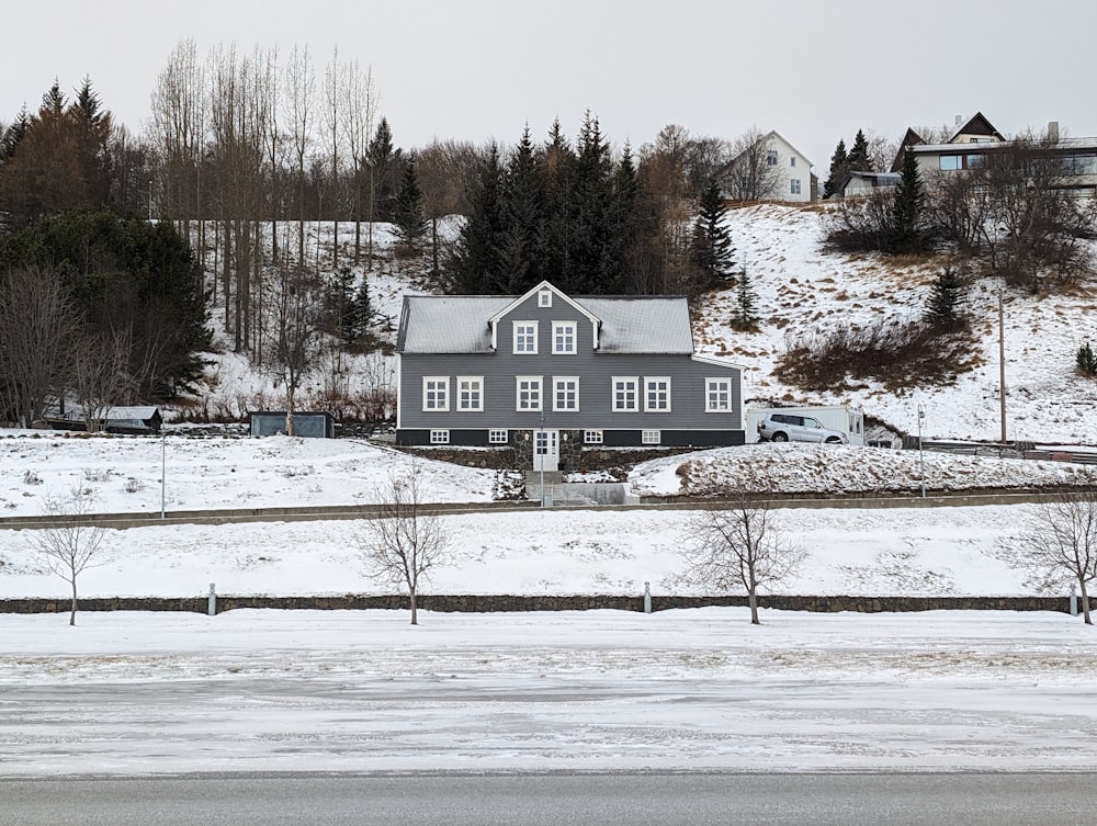 a house in the middle of a snowy field