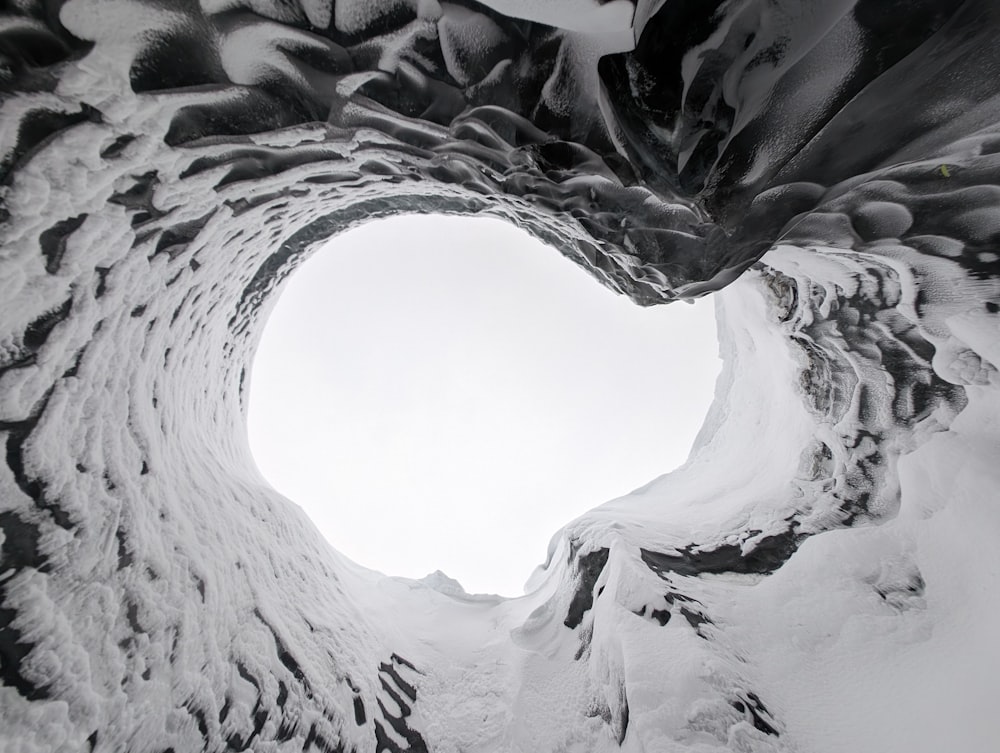 a black and white photo of a snow covered mountain