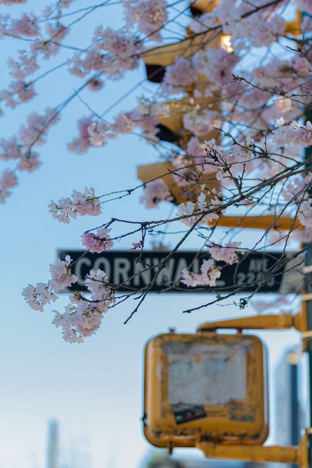 a street sign with a bunch of flowers on it