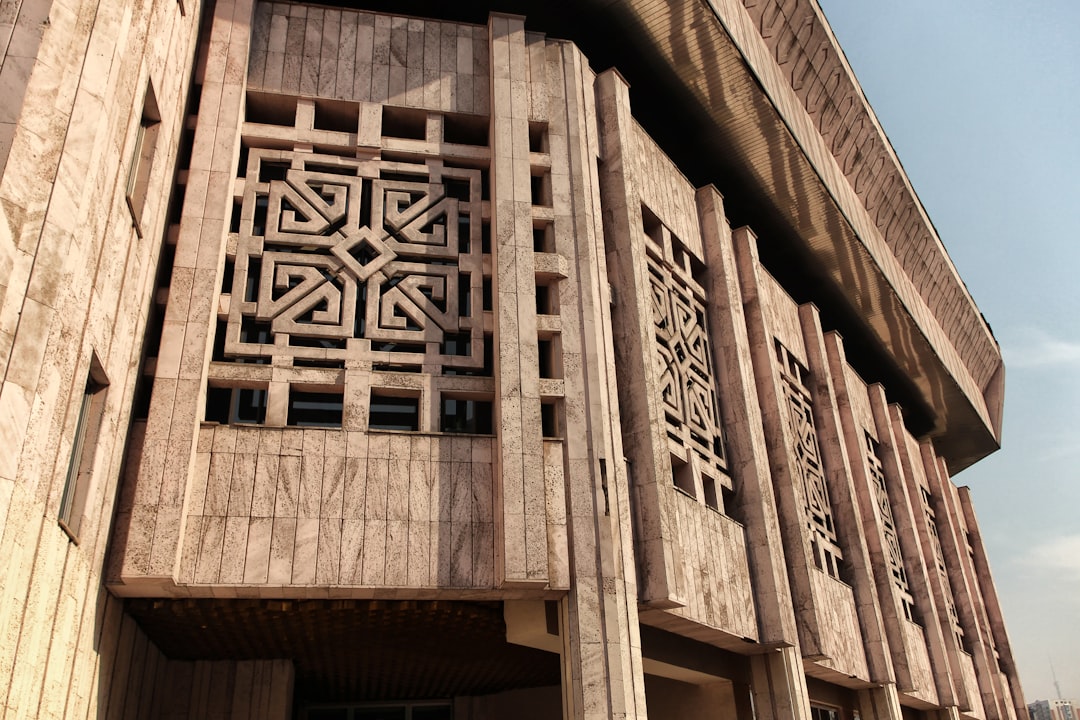 a building with a decorative window on the side of it, A unique design covers the windows of a building on the Al-Farabi campus in Almaty, Kazakhstan.