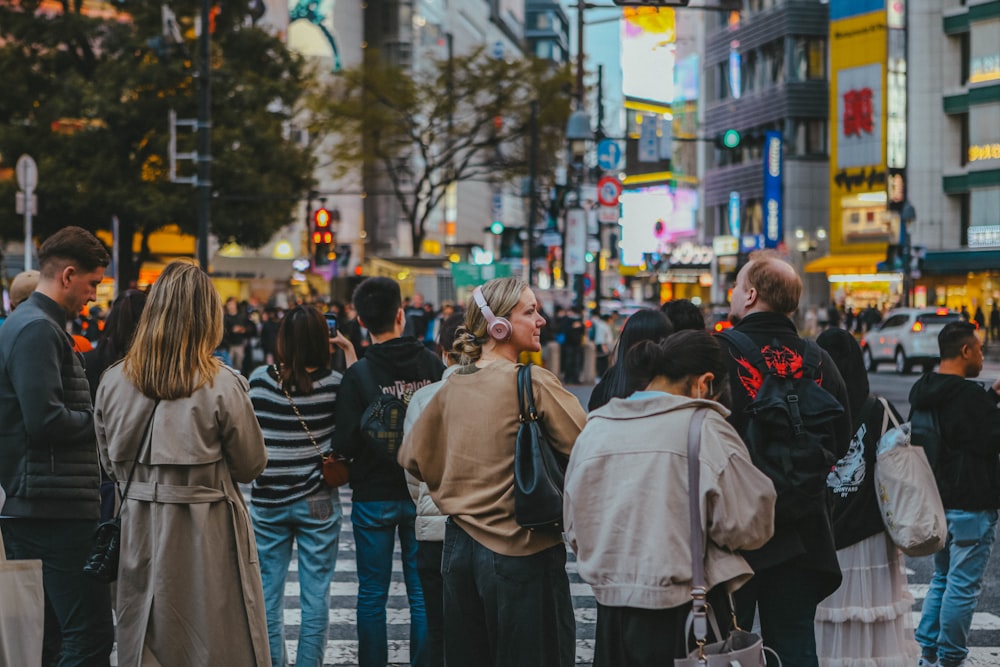 a group of people standing on the side of a road