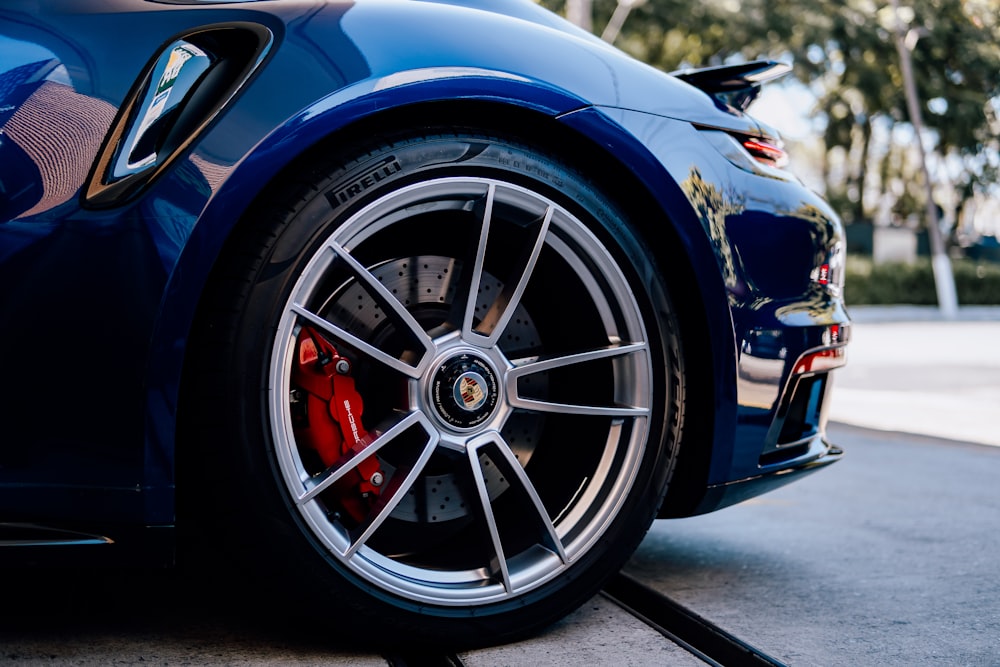 a blue sports car parked on the side of the road