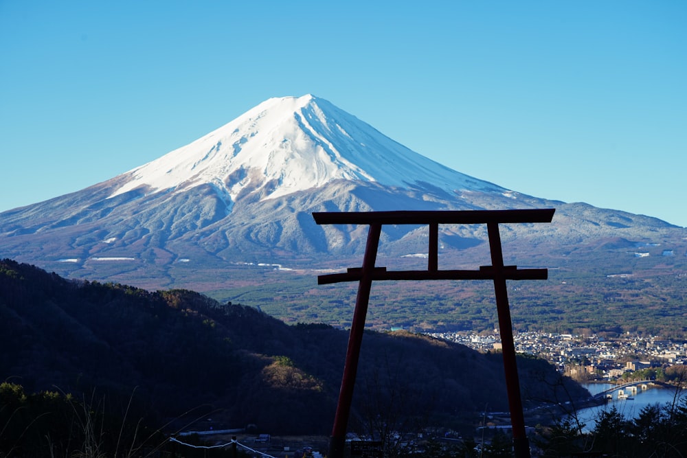 a wooden cross with a mountain in the background