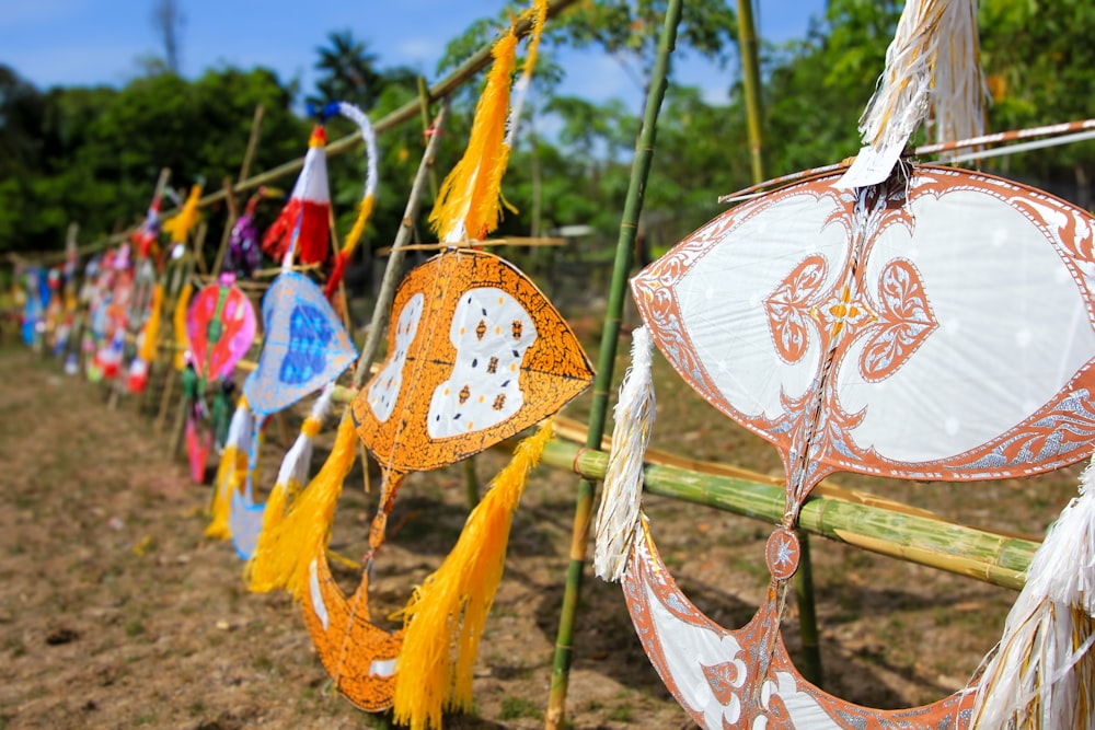 a row of colorful paper lanterns hanging from a bamboo pole