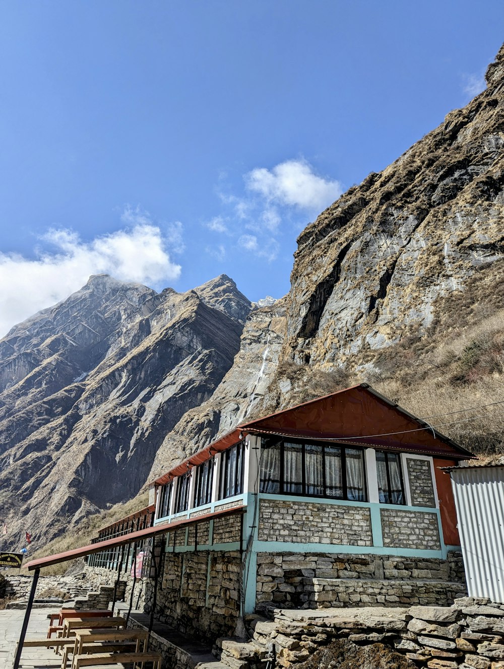 a small building sitting on the side of a mountain