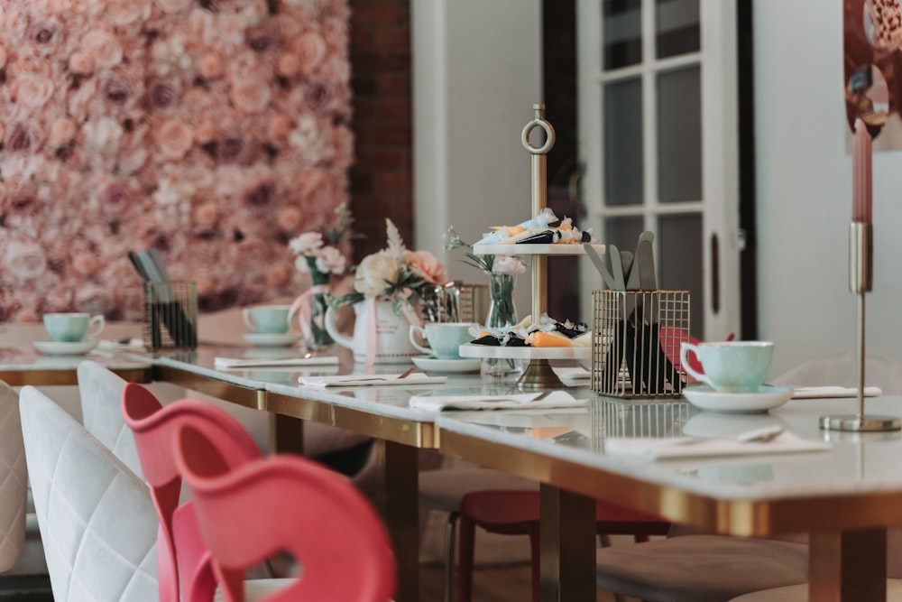 a long table with plates and cups on it